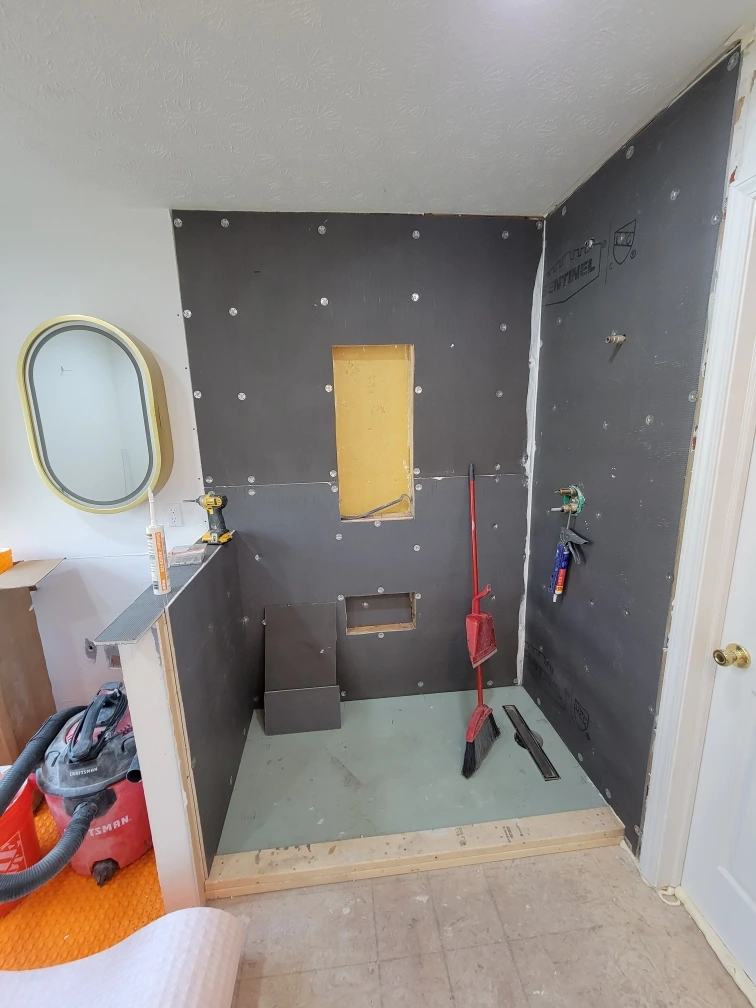Design build process showing bathroom remodeling prep before tile installation