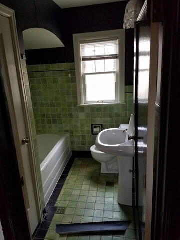 Outdated green tile bathroom before indianapolis in