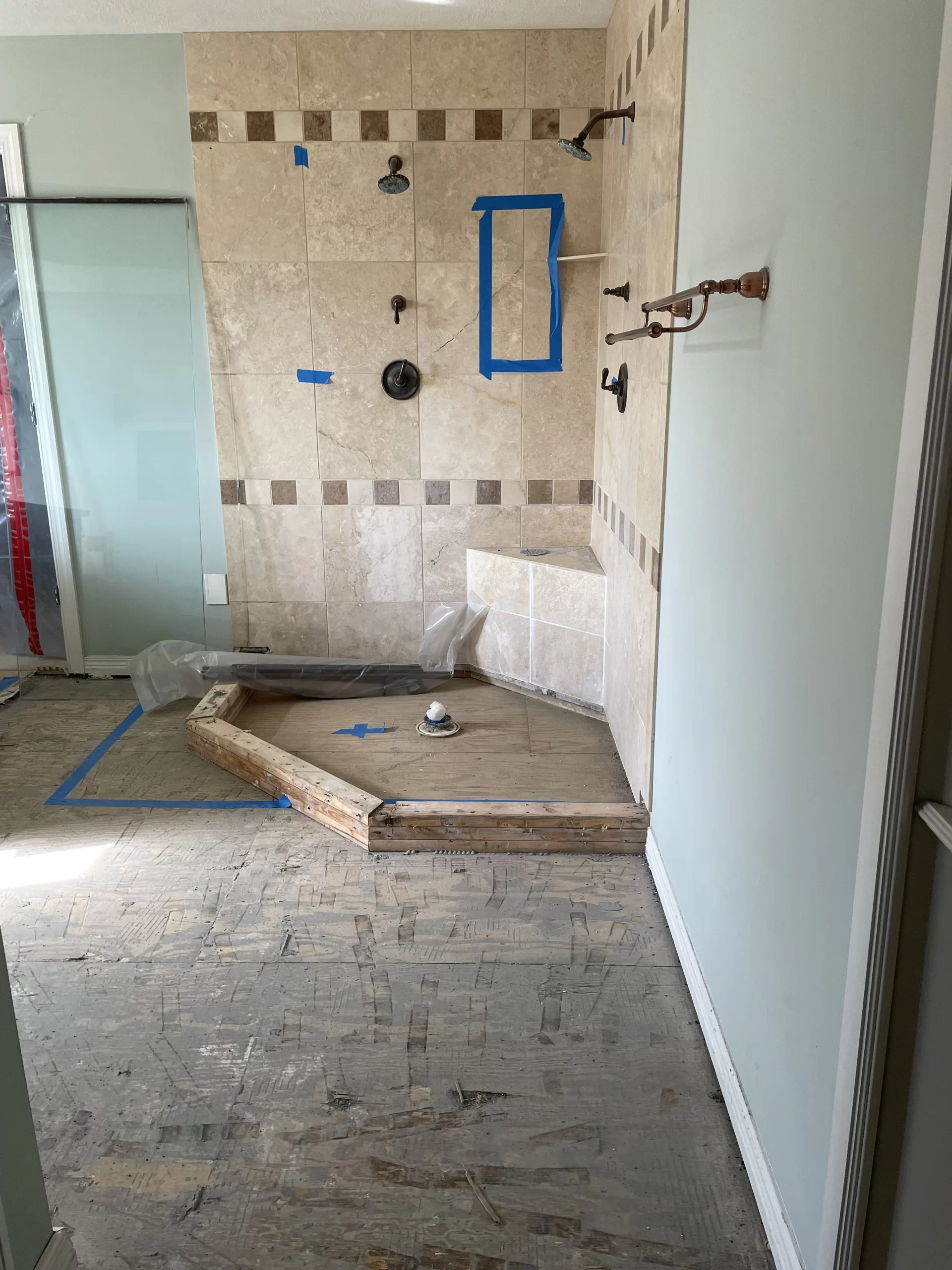Aging shower drain connection failure causing bathroom water damage and subfloor exposure during remodel.