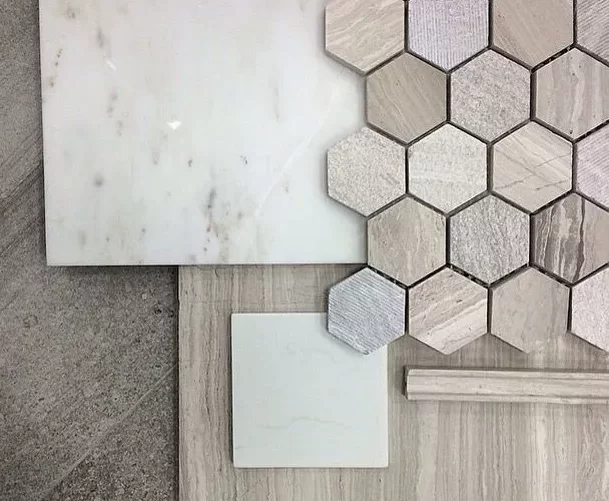 Coordinated bathroom material selections including hex tile, stone, and neutral finishes for a Central Indiana remodel.