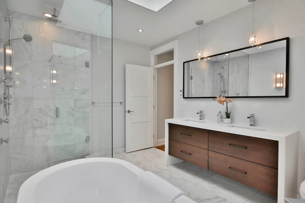 Bathroom remodeling project in Central Indiana with custom wood vanity and glass shower