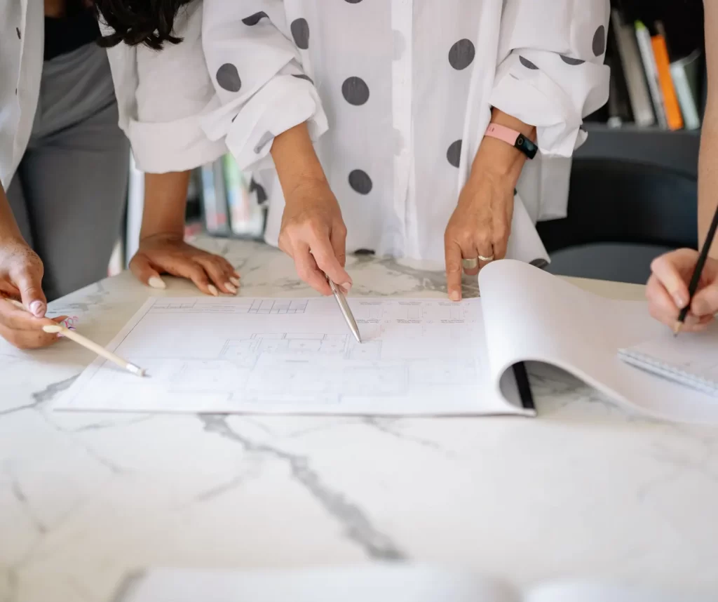 Bathroom remodeling in Central Indiana – design + build team reviewing renovation plans with homeowners