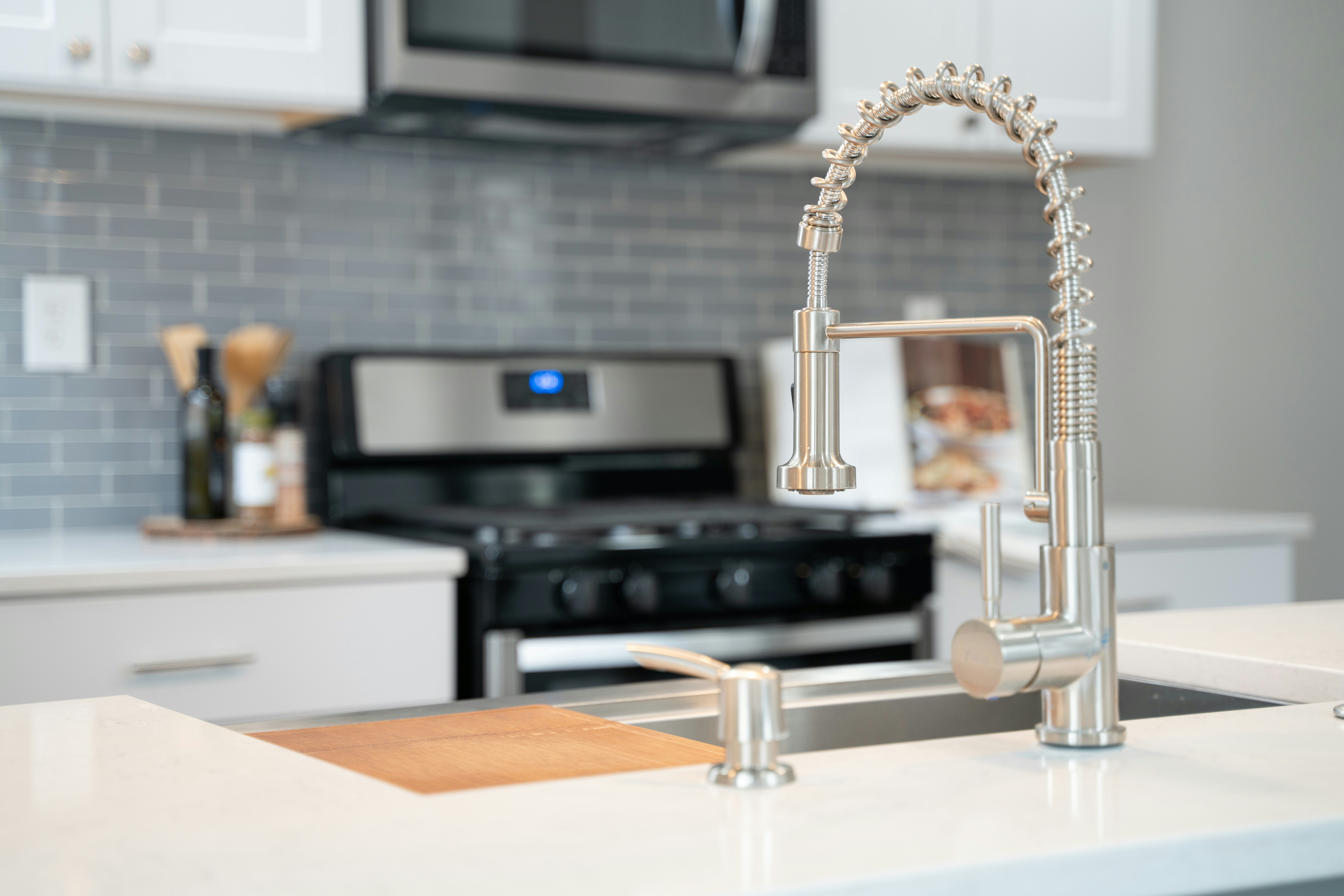 Finished kitchen faucet, countertop, backsplash, and cabinetry detail for a Central Indiana kitchen remodel.