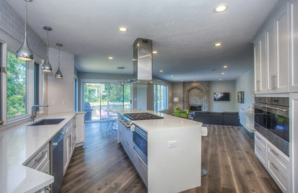 Finished kitchen remodel with island, white cabinetry, and open living area in Central Indiana