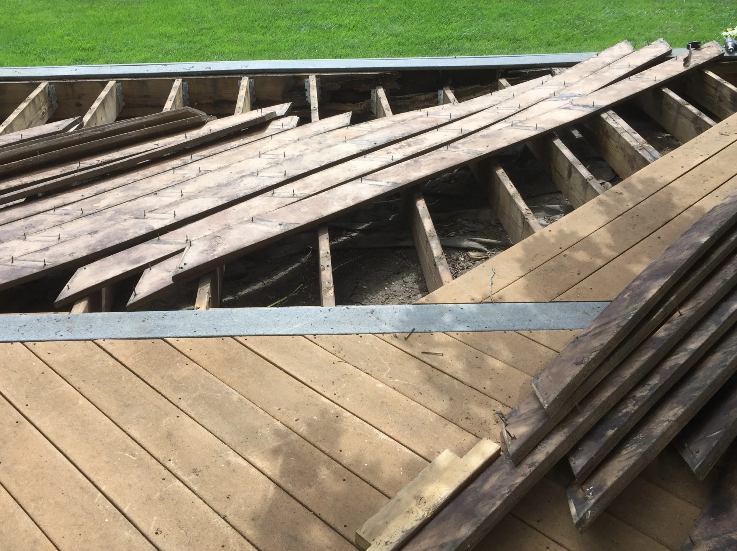 Original composite deck boards removed during demolition in Carmel, Indiana