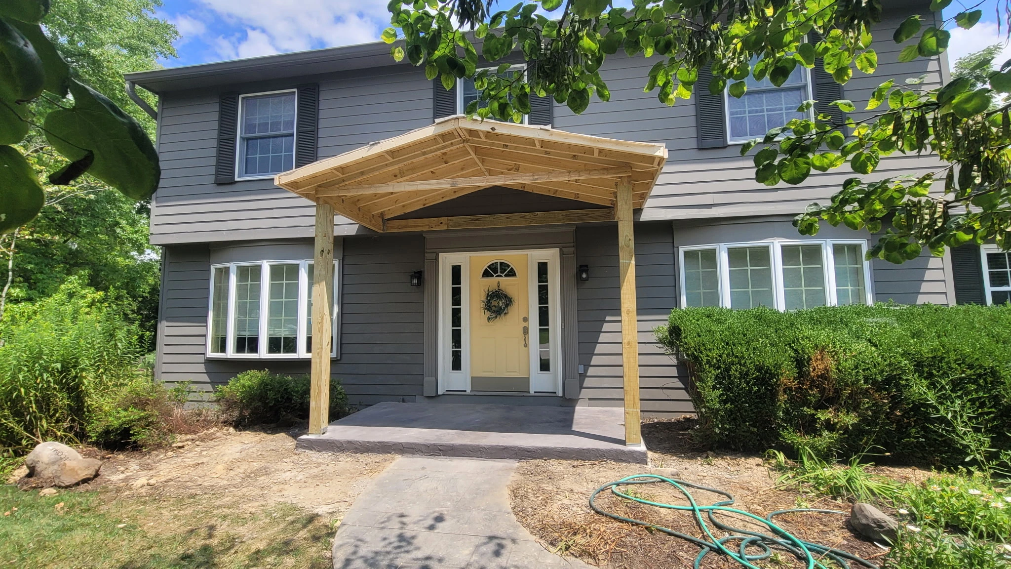 Structural framing for a covered front porch addition in Carmel Indiana