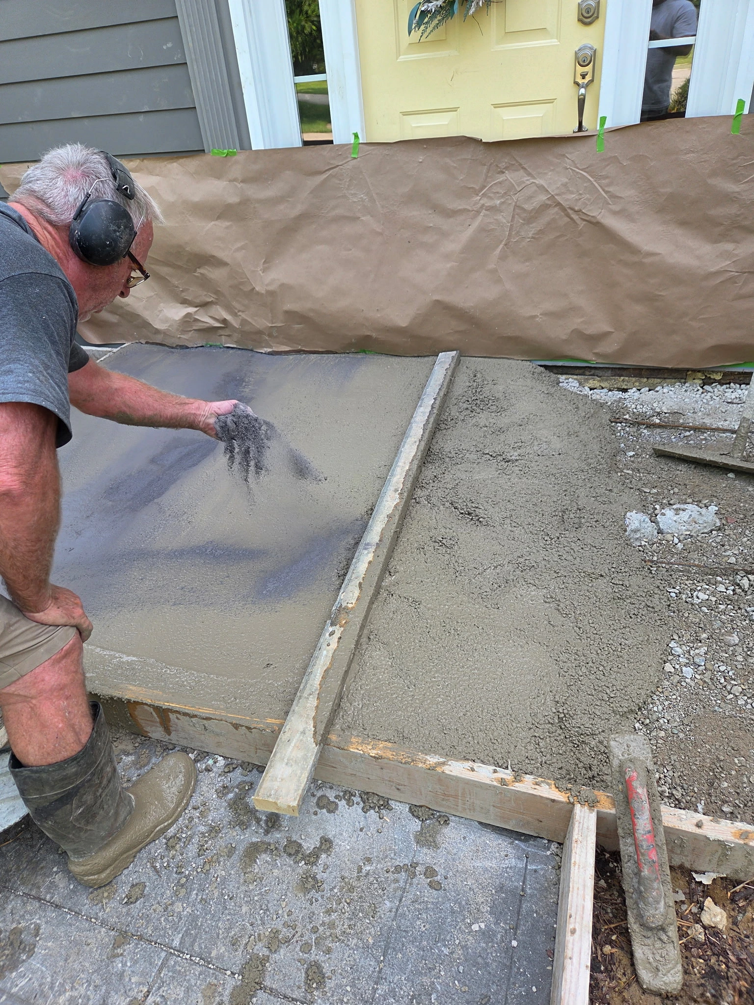 Decorative concrete color being applied to a new front porch landing in Carmel Indiana