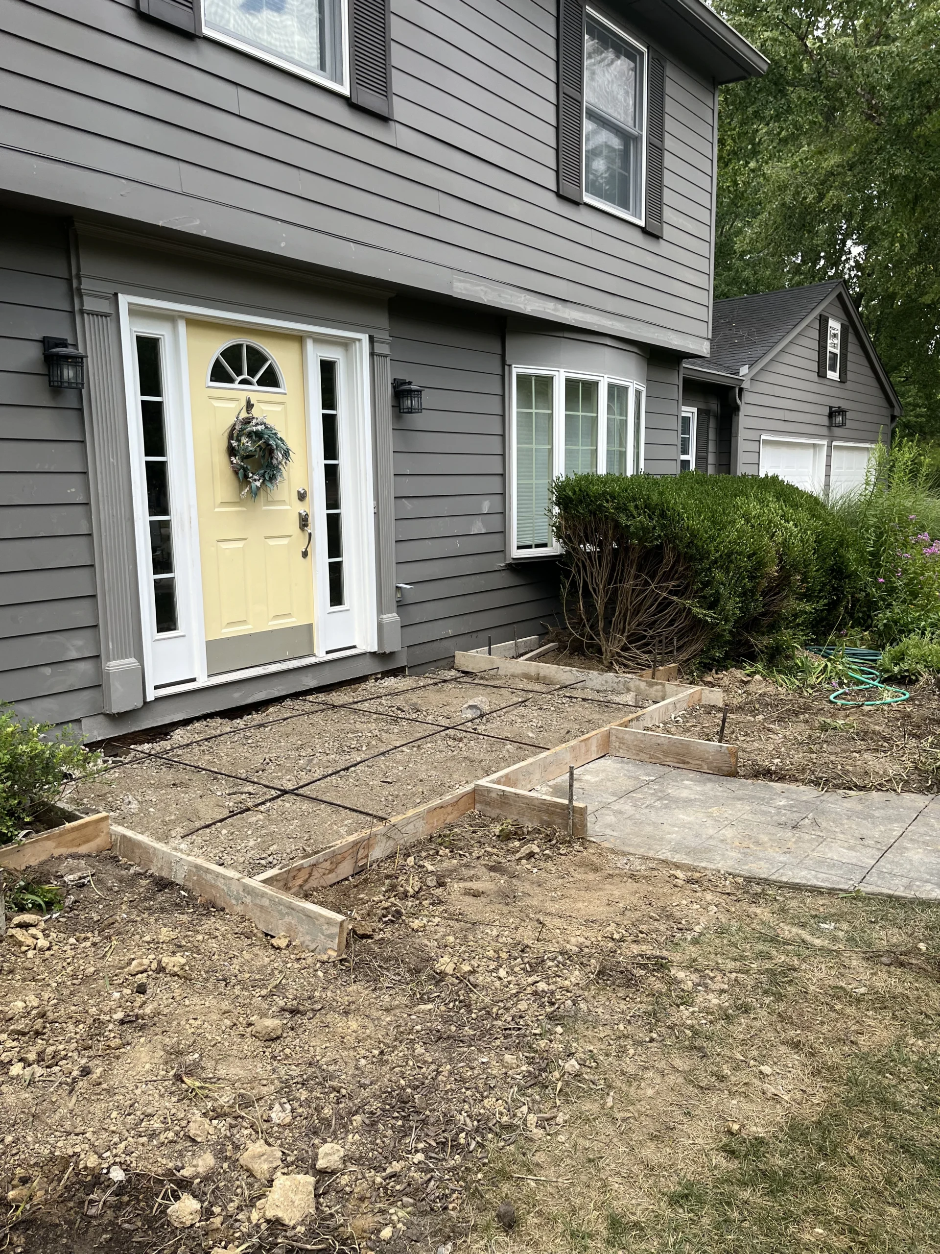 Stamped concrete front porch slab preparation with forms and reinforcing steel in Carmel, Indiana