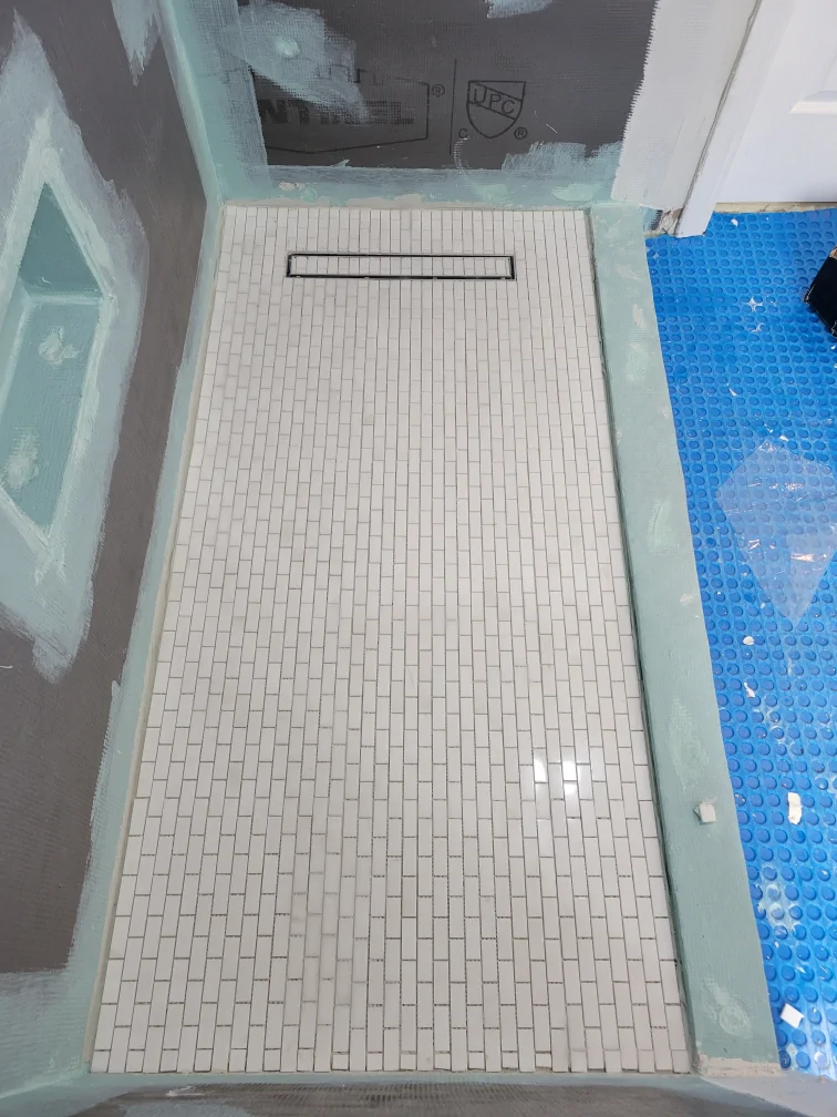 Shower pan and lower wall transition during bathroom waterproofing work