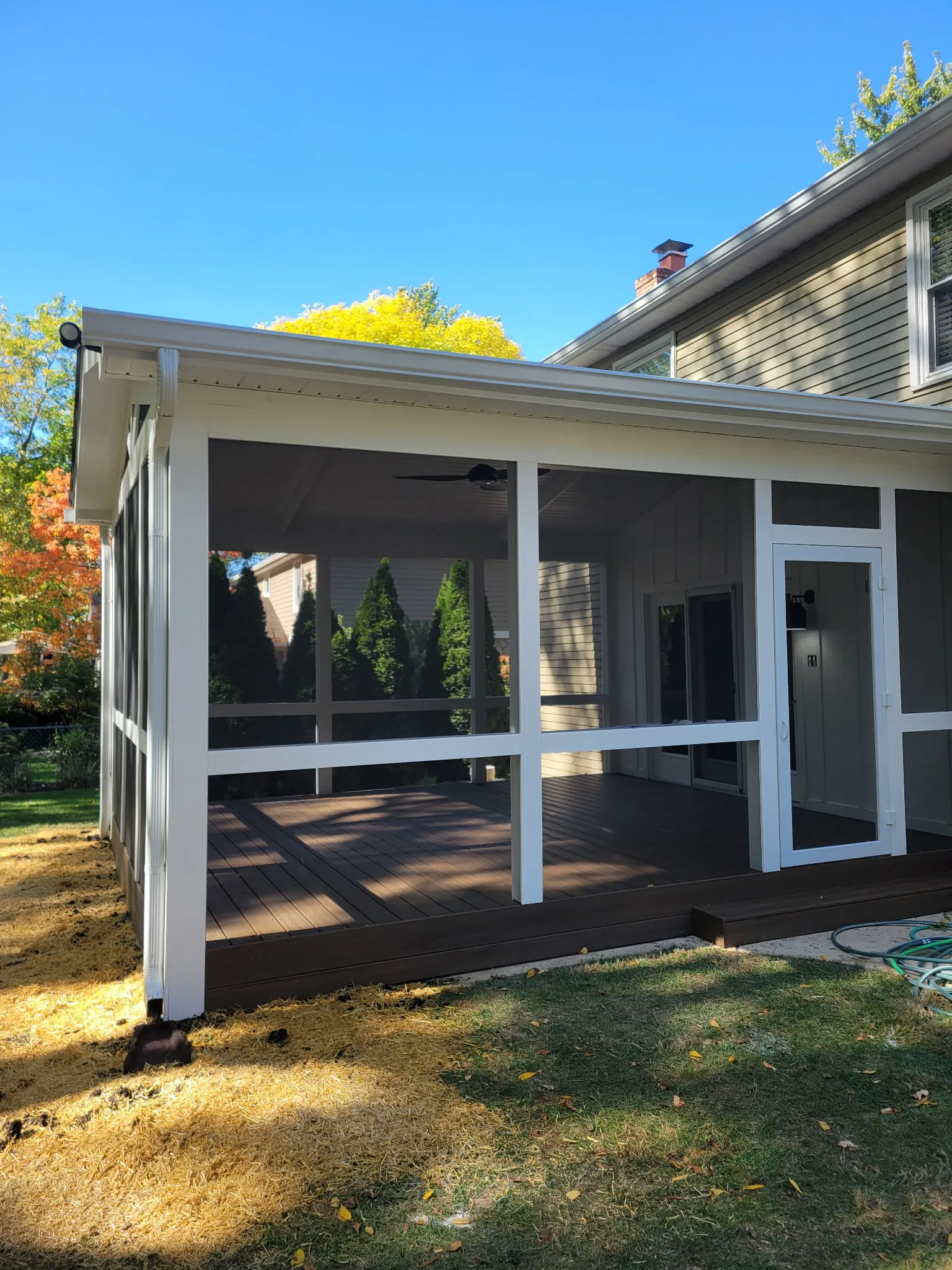 Screened porch roof built below the second-story windows of a Carmel home