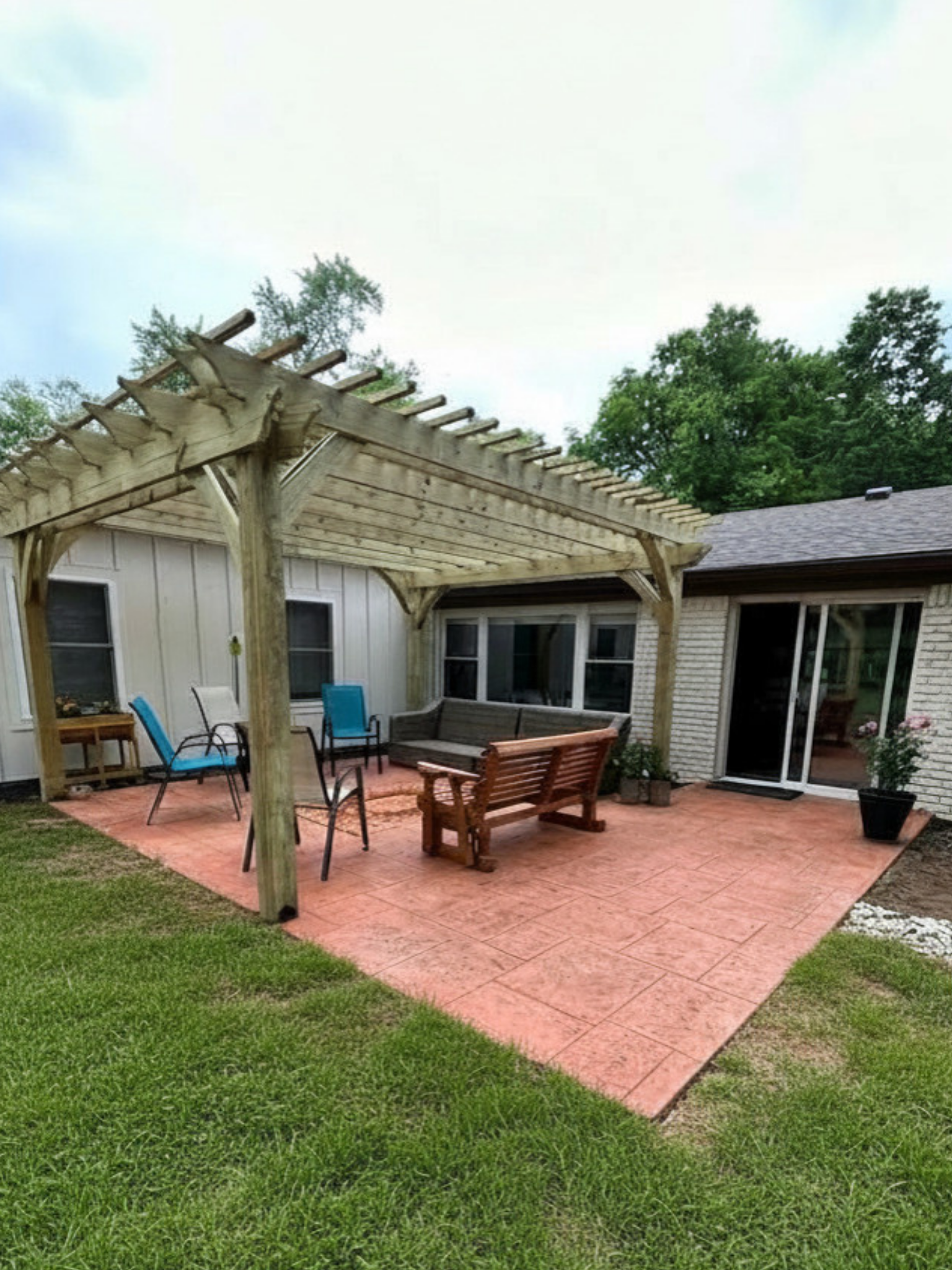 Stamped concrete patio with custom cedar pergola