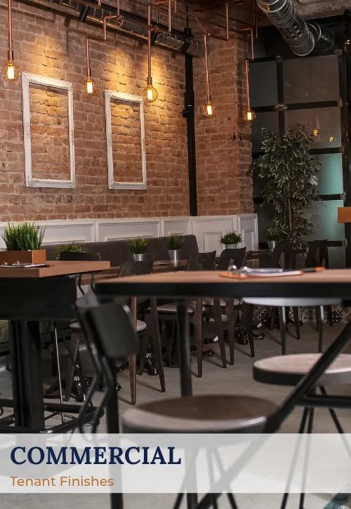 Finished commercial interior with exposed brick walls, pendant lighting, dining tables, and modern finishes