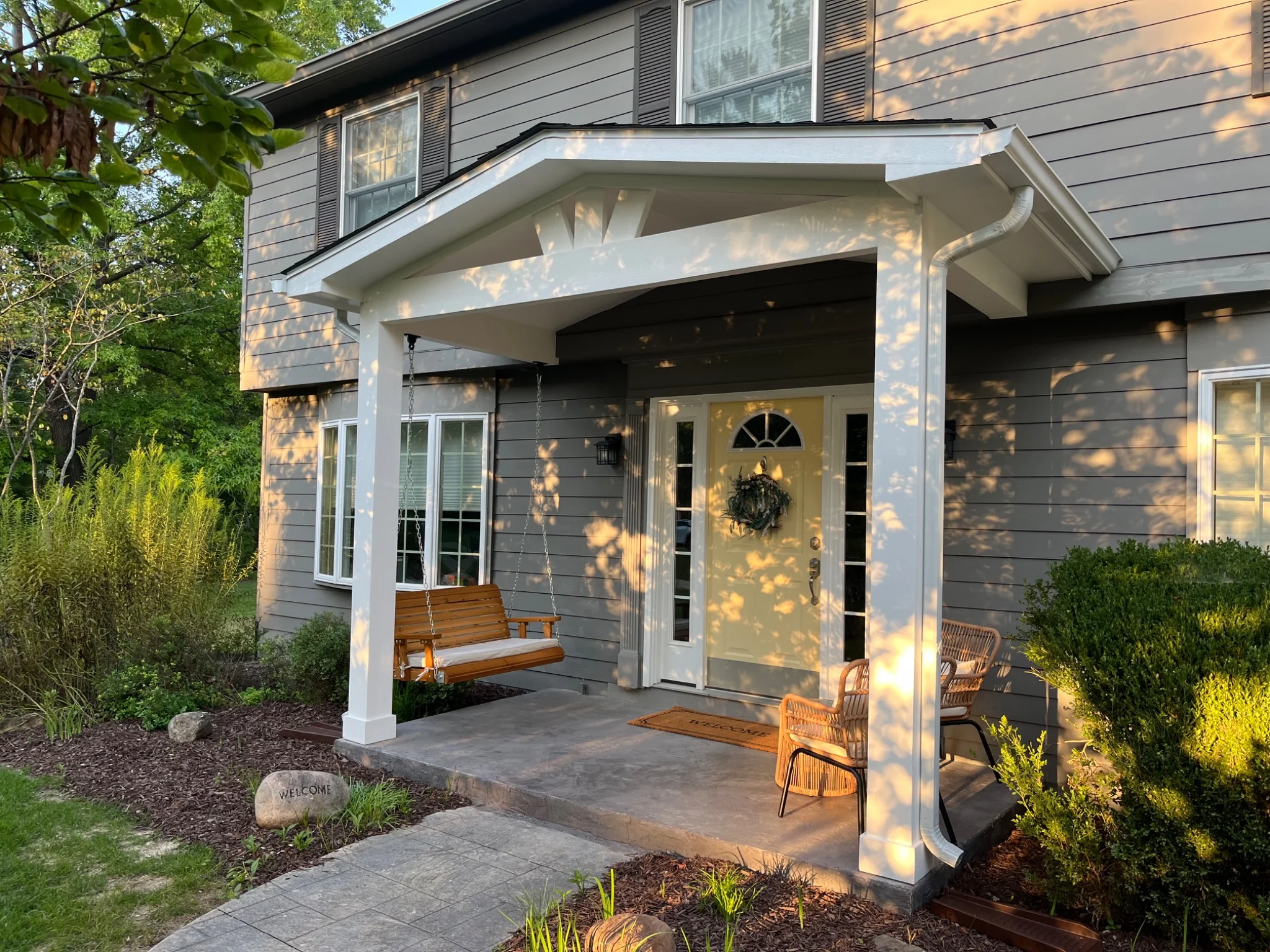 Finished covered front porch with porch swing and seating in Carmel Indiana