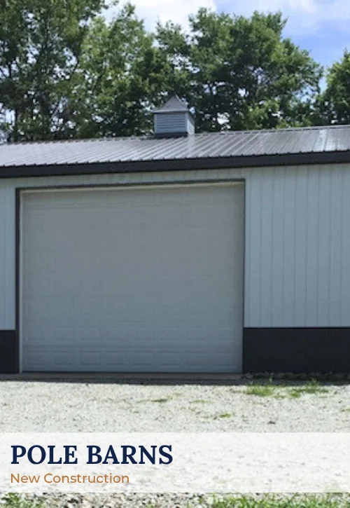 Post-frame pole barn with metal siding, metal roof, and large overhead garage door