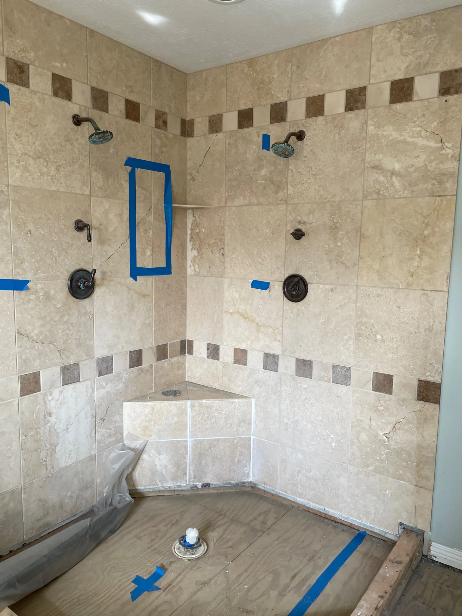 Existing tiled primary bathroom shower before remodeling in Carmel Indiana