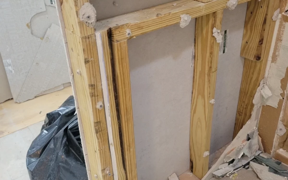 Demo photo of pony wall that once held a glass shower panel but was not properly secured to the floor