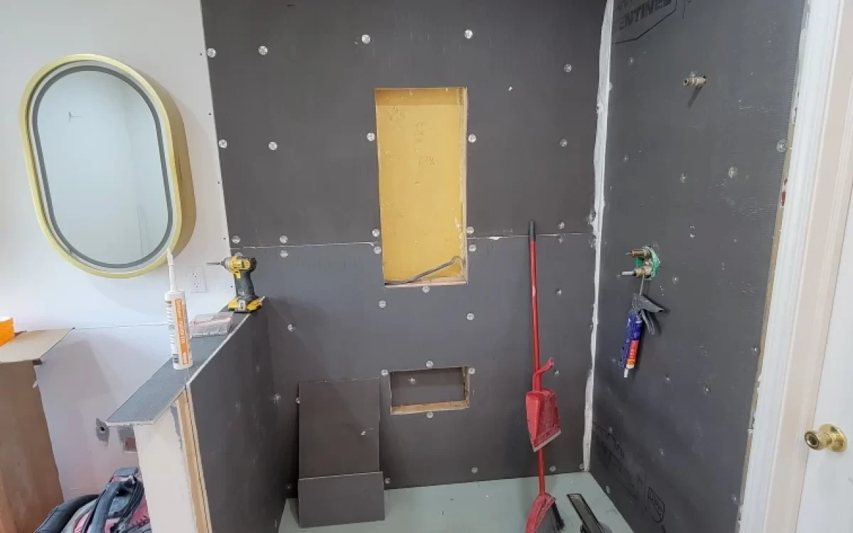 Primary bathroom remodel in progress with new backerboard and niches installed for shower