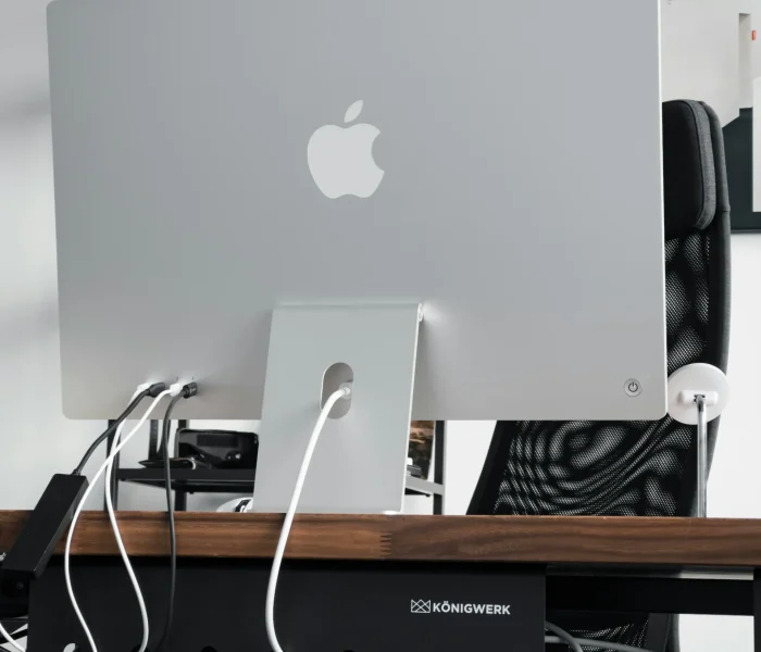 Home office desk with computer monitor, cables, and power management showing the importance of planning electrical infrastructure